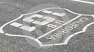 Pacific Coast Highway road marking on asphalt, historic route 101 sign in California, trip in USA.