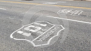 Pacific Coast Highway road marking on asphalt, historic route 101 sign in California, trip in USA.