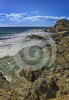 Pacific coast surf beach and rocks in Mexico