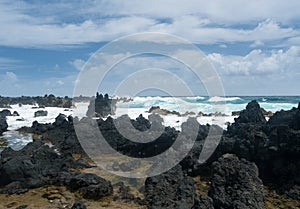 Pacific ocean breaks against lava rocks at Keanae photo