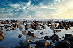 Pacific Ocean coast in El Salvador. Reflection of rocks or stones in the water