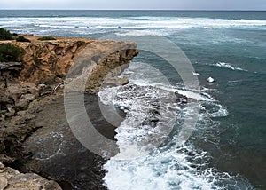 Pacific Ocean's waves against the rocks in Kuai, Hawaii