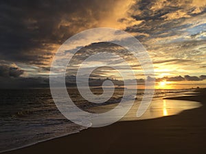 Pacific Ocean Waves at Beach in Kekaha during Sunset on Kauai Island in Hawaii.