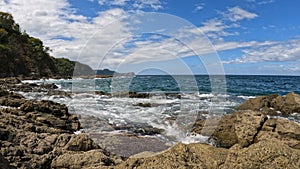 Pacific ocean waves on rock in Playa Ocotal, El Coco Costa Rica