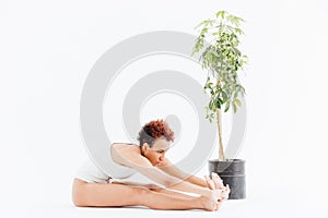 Pacified african american young woman stretching and practicing yoga photo