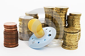 Pacifier with hard money in background
