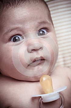 Pacifier, new born baby curled up sleeping on a blanket, multiple expressions