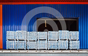 Pack of aluminum ingot bar stack on warehouse dock for container stuffing. Distribution warehouse and industrial raw material logi