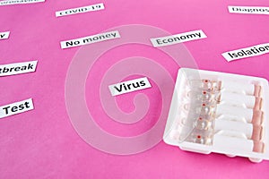 Pack of ampoules with medicine and coronavirus, pandemic headline clipping words on pink background