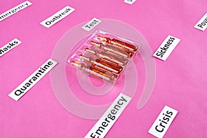 Pack of ampoules with medicine and coronavirus, pandemic headline clipping words on pink background