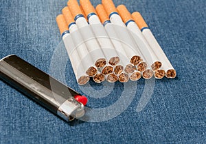 Pack of cigarettes and lighter in pocket jeans