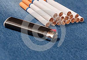 Pack of cigarettes and lighter in pocket jeans