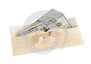Pack of dollars in a beautiful gift envelope on the white isolated background