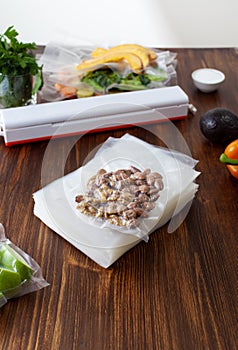 A pack of empty vacuum bags and packed vacuum nuts with vegetables