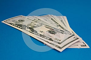 Pack of fifty dollars banknotes isolated on blue background