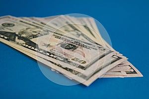 Pack of fifty dollars banknotes isolated on blue background