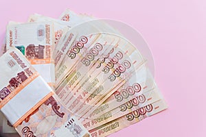 The pack of five thousandth ruble notes in half a million Russian rubles in the banking package is on the background of