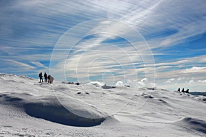 A pack of hikers walking down from Matagalls peak summit on a winter sunny day, Montseny mountains, Barcelona