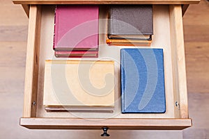 Pack ofl little books in open drawer