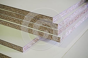 A pack of parts of a particleboard in the furniture manufacturing.