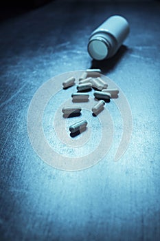 pack of pills on a blue retro table