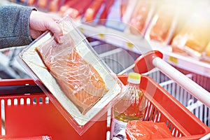 Pack of salmon in hand at store
