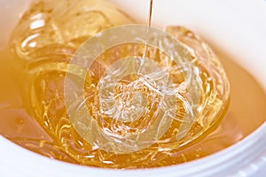A pack of stretchy golden luminous sugaring paste, close-up photo