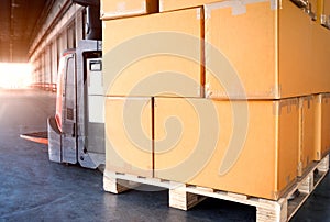 Package Boxes on Pallets and Forklift Pallet Jack. Cardboard Boxes, Warehouse Shipping