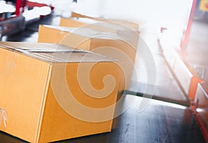 Package Boxes Sorting on Conveyor Belt. Cartons, Parcels Boxes. Storehouse. Distribution Warehouse.