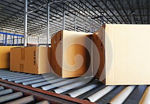 Package boxes sorting on conveyor belt at warehouse photo