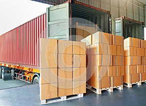 Package Boxes Stack on Pallets Loading into Container Truck. Distribution Warehouse. Container Shipping Logistics.
