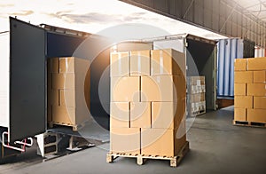 Package Boxes Stack on Wooden Pallets Loading into Container Trucks. Supplies Shipping. Freight Truck Logistic Transport.