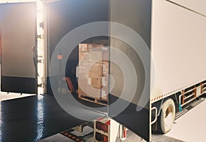 Package Boxes Stack on Wooden Pallets Loading into Container Trucks. Supplies Warehouse Shipping. Freight Truck Logistic