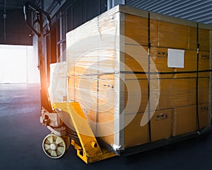 Package Boxes Stacked on Pallets and Hand Pallet Truck. Distribution, Supply Chain. Supplies Warehouse Shipping.