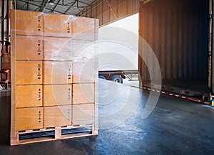 Package Boxes Stacked on Wooden Pallets Loading into Container Trucks. Distribution Supplies Warehouse Shipping.