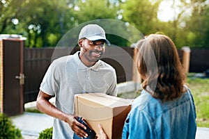 Package Delivering. Delivery Man Delivering Box To Woman