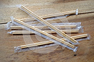 Package of readymade bamboo chopsticks on wooden background