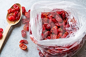 Package of Red Raisins in Plastic Bag with Wooden Spoon.