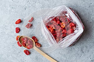 Package of Red Raisins in Plastic Bag with Wooden Spoon.