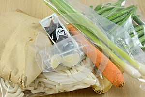Packaged food items in meal delivery kit photo
