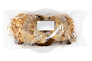 Packaged and labeled root celery on an isolated white background