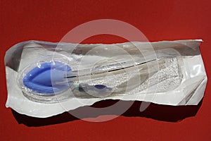 Packaged Laryngeal mask airway for emergency medical help on a red background