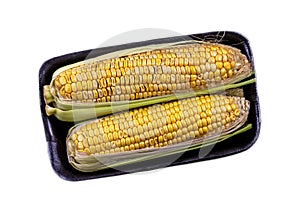 Packaged and sealed fresh grocery store yellow corn. Isolated. on white