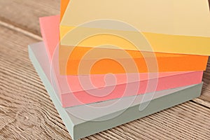 Packages of colorful stickers for notes on a wooden table