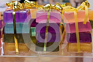 Packages of colourful soap bars, golden ribbon.