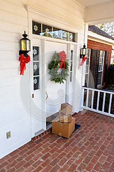 Packages on front porch of home during holiday season