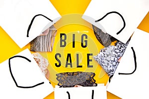 Packaging bags, text Big sale on yellow background Top view Flat lay sesonal sale, retail, shopping concept