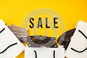 Packaging bags, text Big sale on yellow background Top view Flat lay sesonal sale, retail, shopping concept