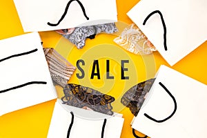 Packaging bags, text Big sale on yellow background Top view Flat lay sesonal sale, retail, shopping concept