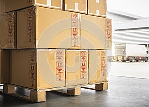 Packaging Boxes Stacked on Pallet Loading with Shipping Cargo Container. Supply Chain Cargo Shipment Transport Logistics
